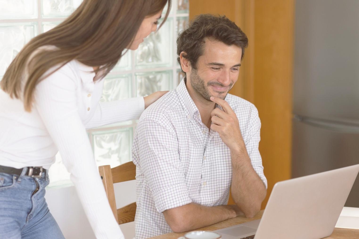 Person reviewing budget spreadsheet with financial planning materials